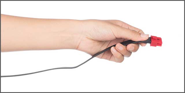 AÂ hand holding power cable