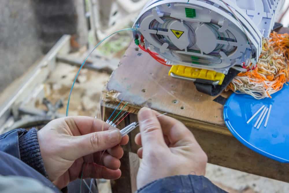 The splicer is checking wires.