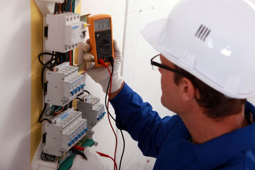 An electrician reading the power output